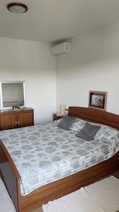 a bedroom with a large bed with a wooden frame at Apartments Petra - 100 m from the Beach in Kampor +71 photos
