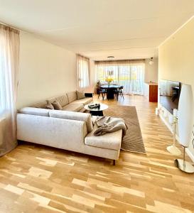 a living room with a couch and a table at Seafront Lux Apt, Central, Beach, Direct Airport Metro in Copenhagen
