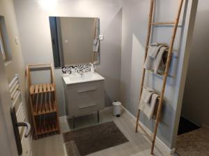 a bathroom with a sink and a mirror at GITE "LE VALLON DE PARAY" in Paray-le-Monial +13 photos