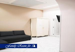a living room with a black couch and a cabinet at Le Ninfe Luxury Rooms in Naples