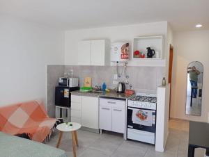 a kitchen with white cabinets and a stove top oven at APARMENT Paraguay 341 in Rosario