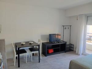 a room with a table and a tv and a bedroom at APARMENT Paraguay 341 in Rosario