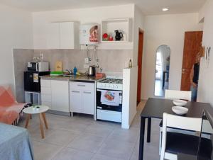 a kitchen with a stove and a table in a room at APARMENT Paraguay 341 in Rosario +1 photo