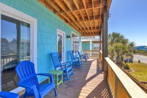 a row of blue chairs on a porch at Life Is Good in Oak Island