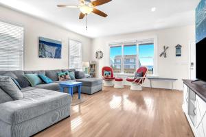 a living room with a couch and a table at Life Is Good in Oak Island +45 photos