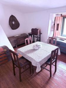 a dining room with a table and chairs and a table and chairsktop at Refugio da Maceira in Marvão