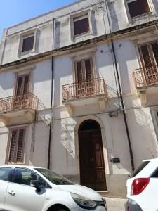a white car parked in front of a building at Casa vacanze So Suite 24 in Reggio di Calabria