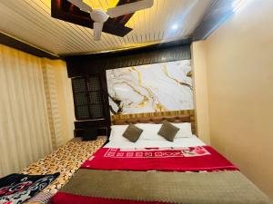 a bedroom with a bed with a painting on the wall at Krishna Villa in Varanasi +64 photos