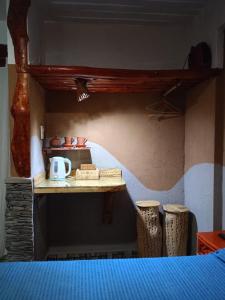 a room with a table with a tea kettle on it at Maité Hospedaje in Santa María