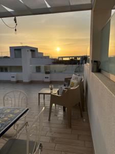 a balcony with a table and chairs on a roof at Casalura in Polignano a Mare