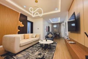 a living room with a couch and a table at Macdestly Apartments in Abuja