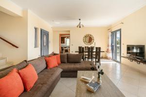 a living room with a couch and a table at Villa Xenia in Karavádhos