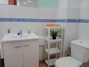 a bathroom with a white sink and a toilet at Loft Centrico - Bahia 2B in Santander