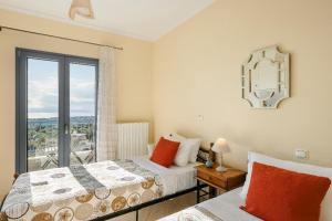 a bedroom with two beds and a window at Villa Xenia in Karavádhos +111 photos