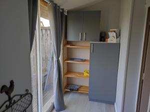 a kitchen with a white refrigerator and a window at GITE "LE VALLON DE PARAY" in Paray-le-Monial
