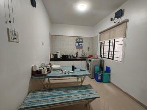 a kitchen with a table in the middle of a room at La vaccanza Suite -403 in Pune