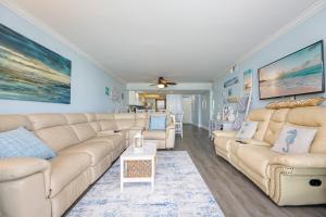 a living room with a couch and a table at Wind Drift 615N condo in Orange Beach +62 photos