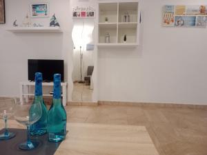 two bottles and glasses on a table in a living room at Loft Centrico - Bahia 2B in Santander