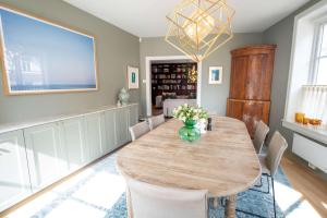 a dining room with a wooden table and chairs at Eksklusiv og sjarmerende leilighet på Frogner in Oslo +19 photos