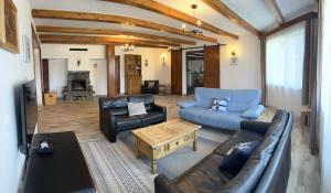 a living room with a couch and a table at Casa Bradut in Dorna Arini