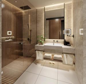 a bathroom with a sink and a shower at Kampala Marriott Hotel in Kampala +26 photos
