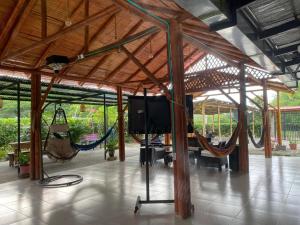a room with hammocks and a tv in a pavilion at Cabañas Spacetatacoa in Villavieja