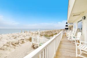 a house with a wooden walkway to the beach at Lisa Lu in Oak Island