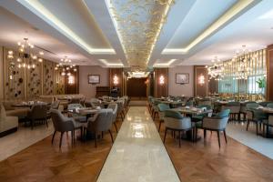 a dining room with tables and chairs and chandeliers at TRYP by Wyndham Istanbul Maltepe in Istanbul