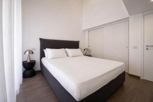 a bedroom with a large white bed with a black headboard at Maison Michela Sorrento in Sorrento