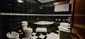 a bathroom with two toilets and a tub and a sink at Casa das Boucinhas in São Sebastião de Penha Longa +27 photos