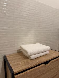 two white towels sitting on top of a wooden table at Kaz KAFE in Mamoudzou +36 photos