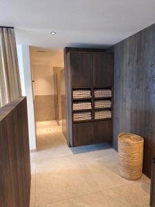 a bathroom with a wooden cabinet and a walk in shower at Residence Gloria Dei in Schenna