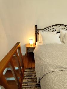 a bedroom with a bed and a table with a lamp at Blue house II in Palekastron