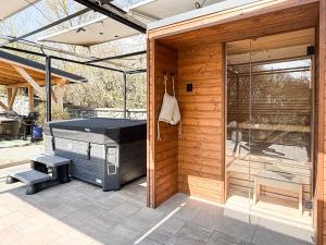 a barbecue grill on a patio next to a glass door at Zanzara Guesthouse in Pákozd