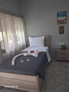 a bedroom with a bed with flowers on it at Irina's Stoudio 7 in Psakoudia