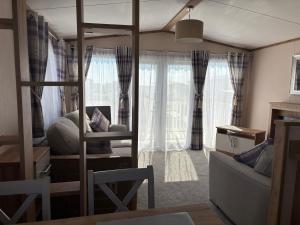 a living room with a bunk bed and a couch at Hardys Caravan Park in Ingoldmells
