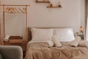 a bedroom with a bed with white pillows at Tonella Studio in Corfu