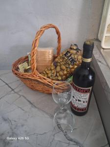 a basket and a wine glass and a bottle of wine at Irina's Stoudio 7 in Psakoudia