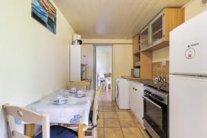 a small kitchen with a table and a table and chairs at L'Océane in Apremont +18 photos
