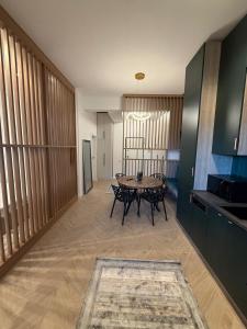 a kitchen with a table and chairs in a room at Tomis Villa Center Studio in Constanţa