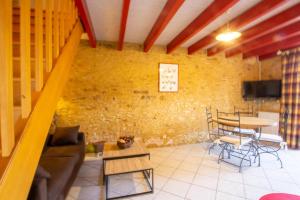 a living room with a couch and a table at Domaine de pommarede in Carsac-Aillac