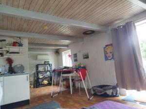 a kitchen with a table and chairs in a room at Small House ærø in Marstal +4 photos