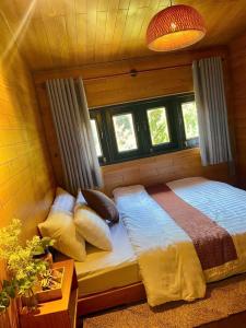 a bedroom with a bed with pillows on it at tiny house in Ấp An Kroët
