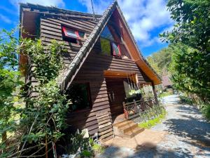 a log cabin with stairs to the front of it at tiny house in Ấp An Kroët