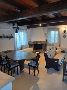 a living room with a large wooden table and chairs at Scenic Coastal Getaway in Porto Lafia