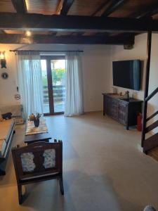 a large living room with a flat screen tv at Scenic Coastal Getaway in Porto Lafia
