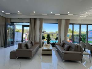 a living room with two couches and a table at Villa Ban Mai in Tài Xá