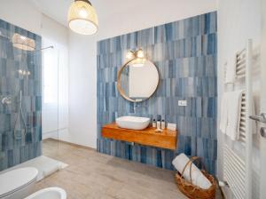 a bathroom with a sink and a mirror at Casa Bambu in Polignano a Mare