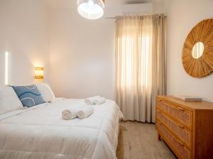 a bedroom with a large bed with towels on it at Casa Bambu in Polignano a Mare +7 photos