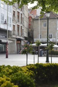 a street with trees and buildings in a city at Hotel Marín in Marín +28 photos